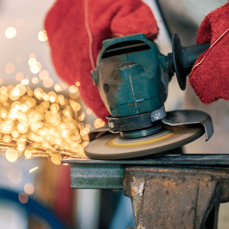 An angle grinder being used with gloves