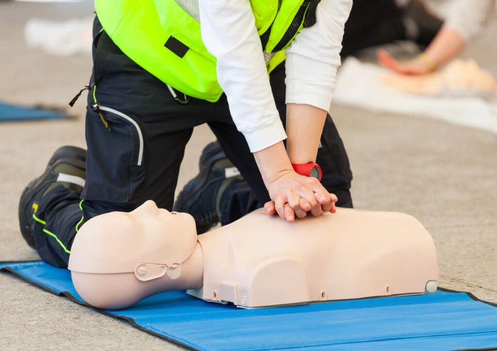 CPR Training with Mannequin on Blue Mat