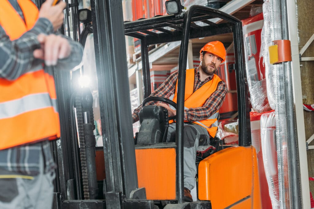 Man Operating Forklift in Warehouse Environment